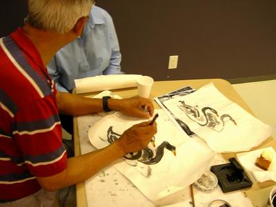 Charles Leung helps workshop participant with pointers on trumpeter swans