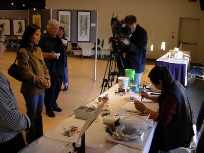 Kathy Matsushita demonstrates for exhibition onlookers and media